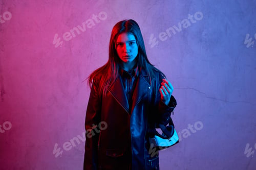 Preview: Young girl holding virtual reality helmet while wearing a jacket