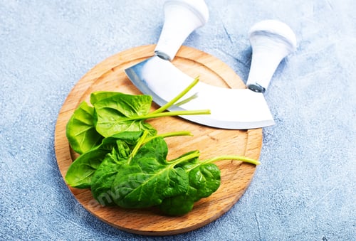 Fresh Spinach with Cutting Knives on Wooden Board