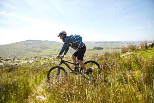 Preview: Cyclist cycling on hillside