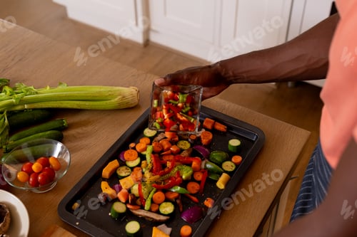 Preview: Hands of african american man preparing meal in kitchen