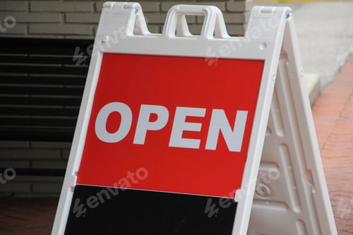 Preview: A frame sign with the word Open written on white letters on a red background with black space