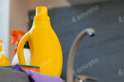 Preview: Household chemicals product bottles standing near the kitchen sink