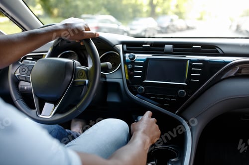 Preview: Unrecognizable black man driver sitting in brand new auto