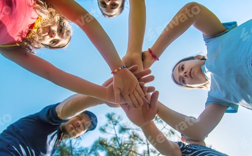 Preview: People put their hands together. Selective focus.