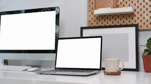 Preview: Modern workspace with laptop computer with empty screen on white desk at home office.