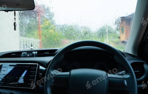 Preview: Car driving in rain and storm. Water drops or rain in front of mirror of car