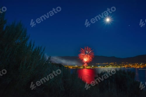 Preview: Canada Day celebration over Okanagan Lake, full moon in sky, Penticton, British Columbia, Canada