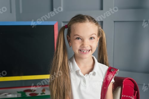 Preview: School child in a classroom with blackboard. Back to school