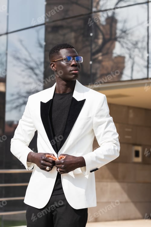 Preview: Stylish African American businessman in eyeglasses in town