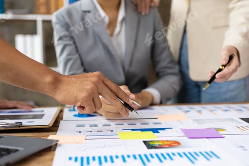 Preview: Business people discuss marketing growth chart and make business plan.
