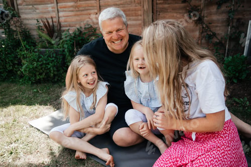 Family Smiles Outdoors in Garden Setting