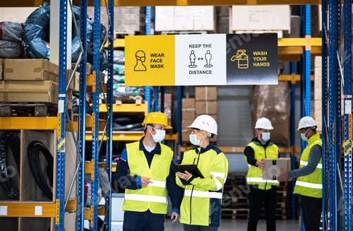 Preview: Group of workers with face mask working indoors in warehouse, coronavirus concept.