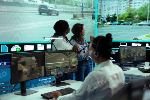 Preview: Diverse experts following city traffic on a display in monitoring room