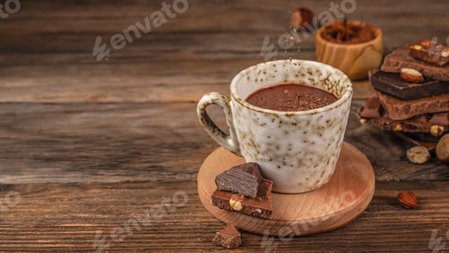 Preview: Cup of hot chocolate on wooden table with falling cocoa powder