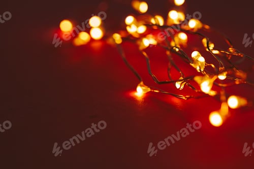 Preview: Red background with illuminated lights of garland