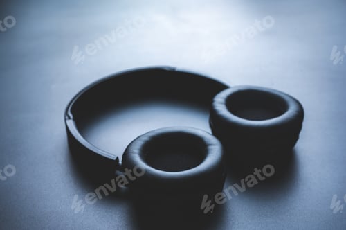 Preview: Solo wireless black bluetooth headphones lying alone on black background