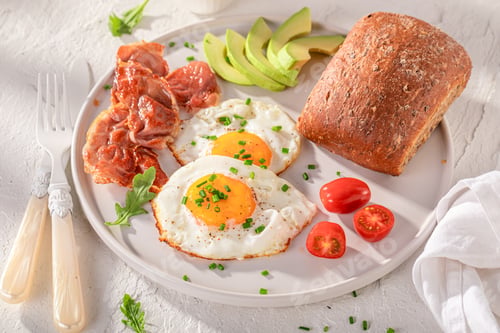 Preview: Fresh and tasty breakfast with egg, tomato and rolls.