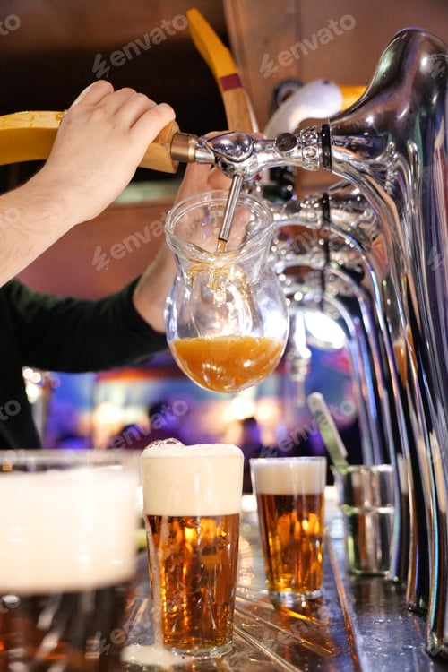 Preview: bartender tapping beer in a pub