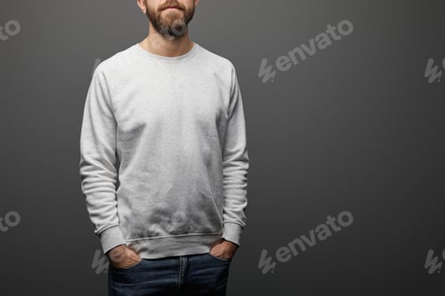 Preview: cropped view of bearded man with hands in pockets in blank basic grey sweatshirt on black background