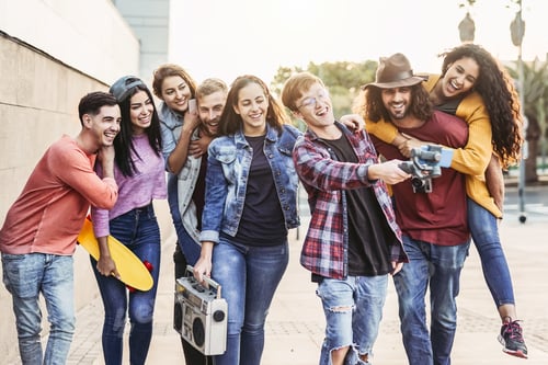 Preview: Happy young friends filming video with gimbal mobile smartphone outdoor