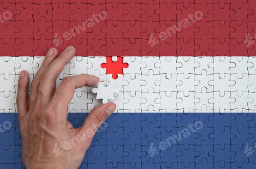 Preview: Netherlands flag is depicted on a puzzle, which the man's hand completes to fold.