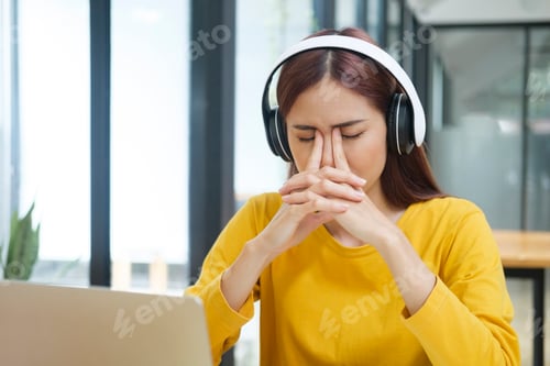 Preview: Young woman having headache and stress from work or study.