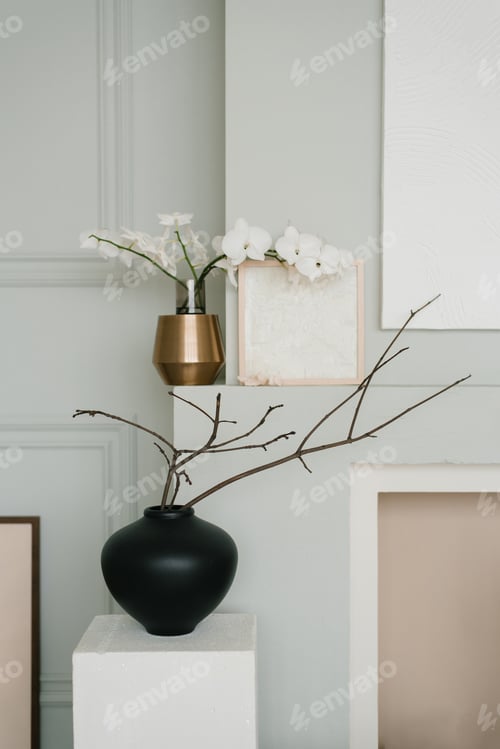Preview: Stylish minimalist Scandinavian living room decor in gray. Branches of spring trees in vases