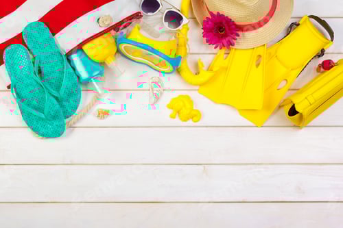 Preview: Summer beach essentials laid out on a wooden surface ready for fun in the sun