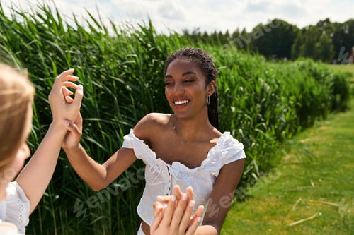 Preview: Young couple embracing love and joy in a sunny green field on a cheerful day