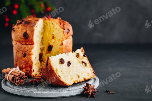 Preview: Traditional Christmas Panettone cake with dried fruits on dark stone background