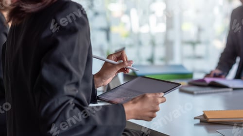 Preview: Businesswoman meeting sharing ideas together in the office using a tablet and documents placed on th