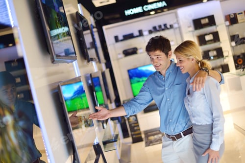 Preview: People In Consumer Electronics Retail Store Looking At Latest Laptop, Television And Photo Camera
