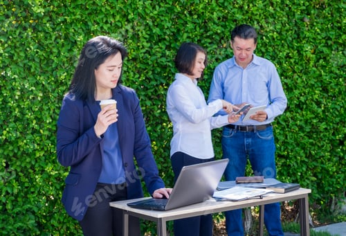 Preview: Businesswoman and businessman working outside office