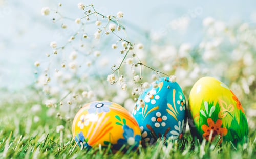 Preview: Three Easter eggs on green grass.
