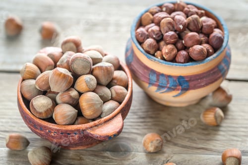 Preview: Rustic bowls of hazelnuts on the wooden table