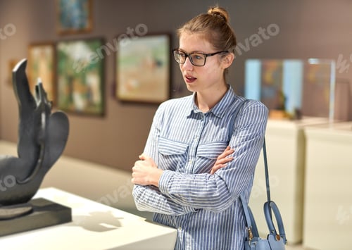 Preview: Woman Visitor In Historical Museum Looking At Art Object