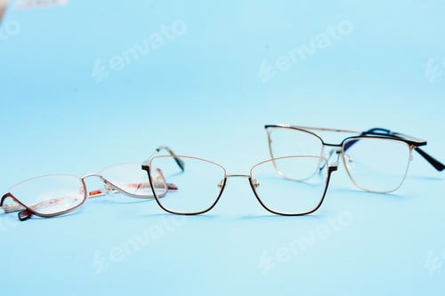 Preview: pair of red plastic-rimmed eyeglasses on a blue background