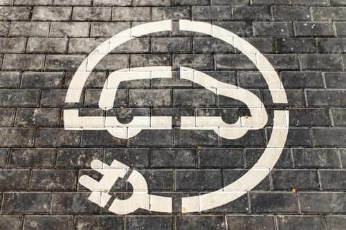 Preview: Roadsign of free electric car charging station in a European supermarket parking lot.