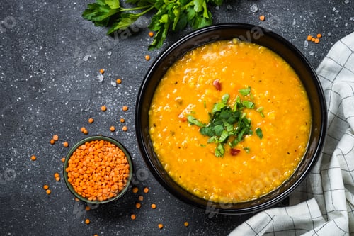 Preview: Red lentil soup on black top view