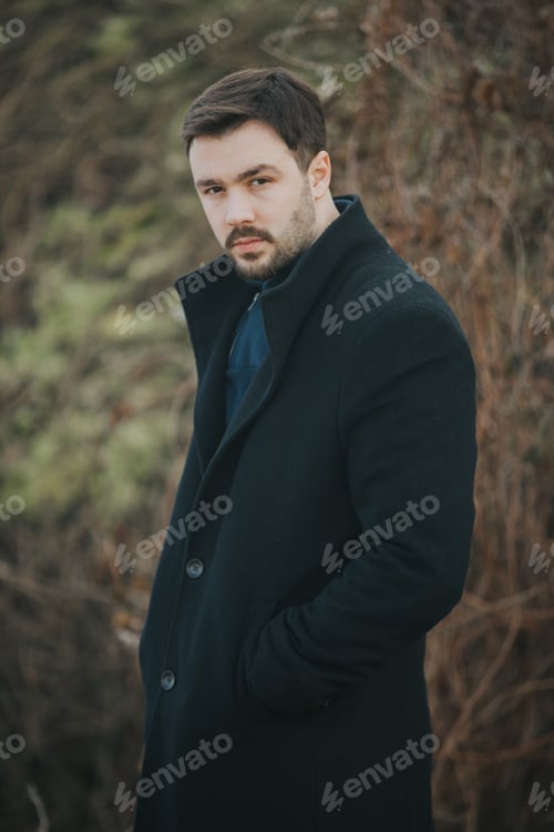 Preview: Caucasian male with a coat posing in nature