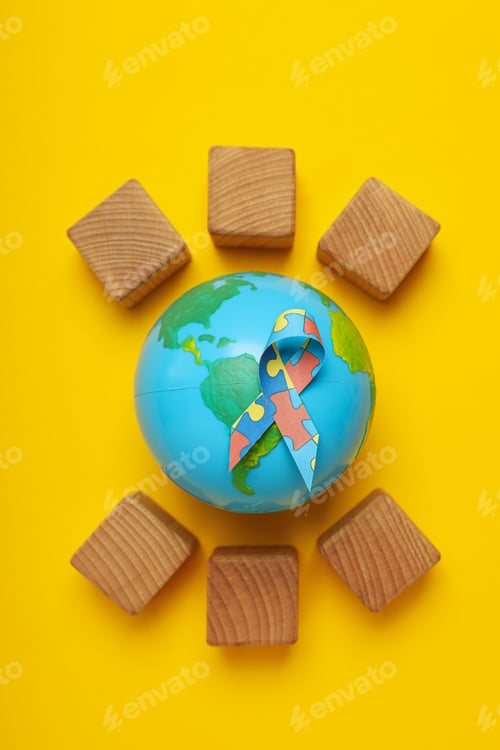 Preview: A ribbon with colorful puzzle pieces, cubes and a model of the planet Earth on a light background