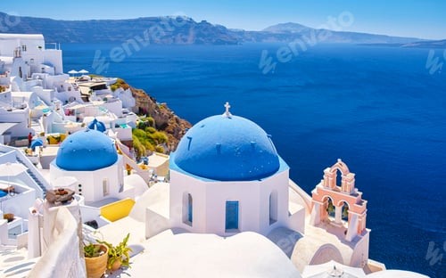 Preview: White churches an blue domes by the ocean of Oia Santorini Greece, traditional Greek village