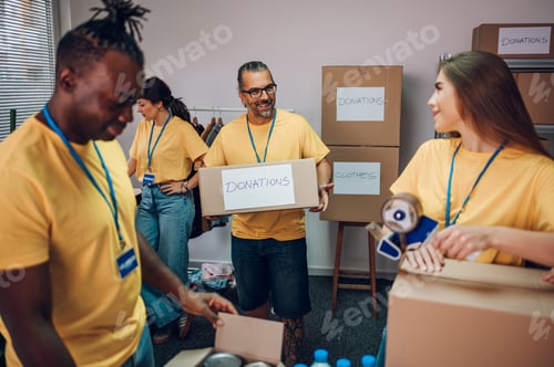Preview: Group of multiracial volunteers working in community charity donation center