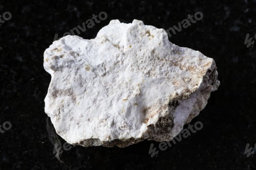 Preview: sample of rough albite rock on black granite