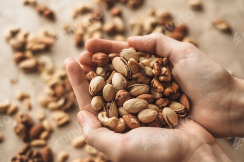 Preview: Different types of nuts, nut mix of almonds, hazelnuts, cashews, peanuts in hands.