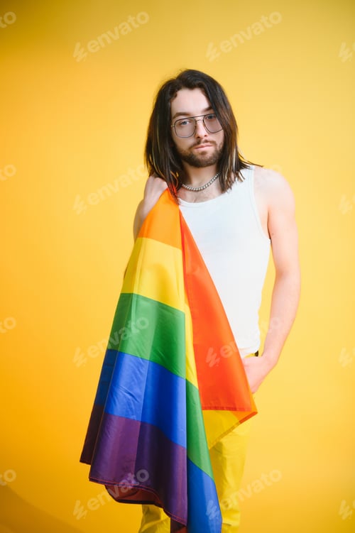 Preview: Young Man Holds a Pride Flag on Yellow