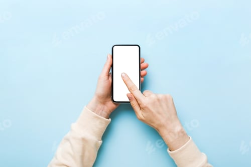Preview: Top view of woman hands holding smart phone with blank copy space screen for your text message