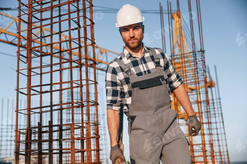 Preview: Front view of man that is working on the construction site at daytime