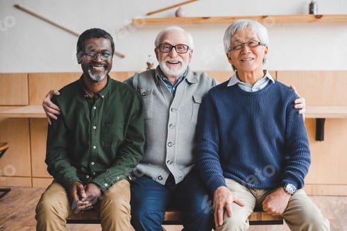 Preview: group of senior friends embracing and looking at camera
