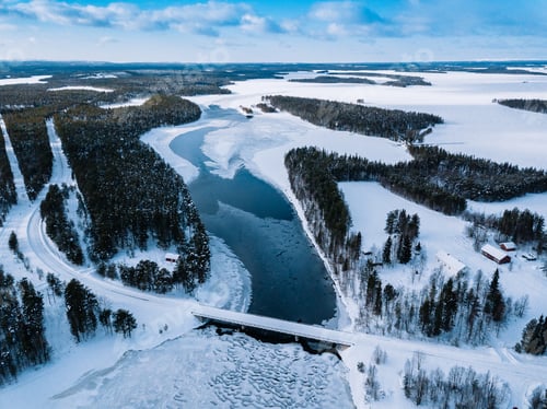 Preview: Aerial top view of bridge road above frozen river in snow winter Finland.